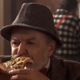 Food critic eating slice of pizza